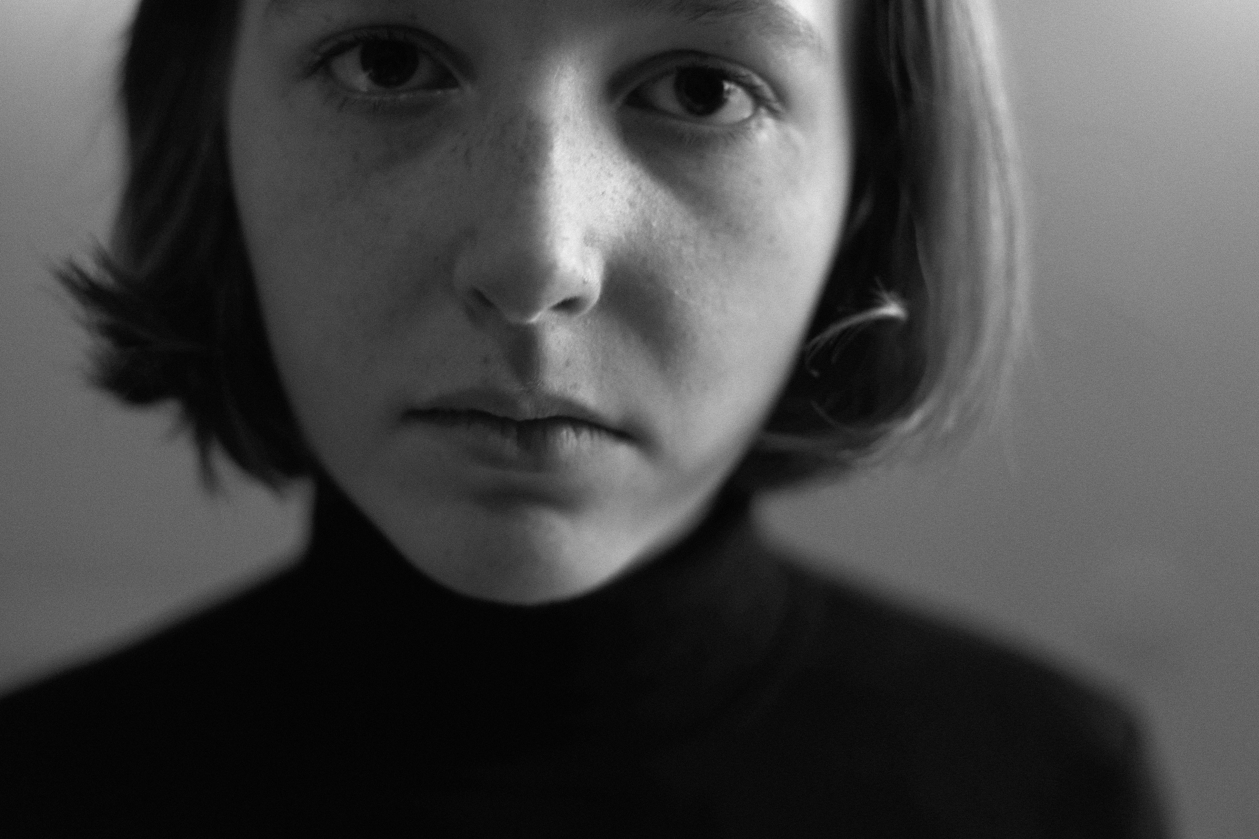 A black and white close up photo of a girl