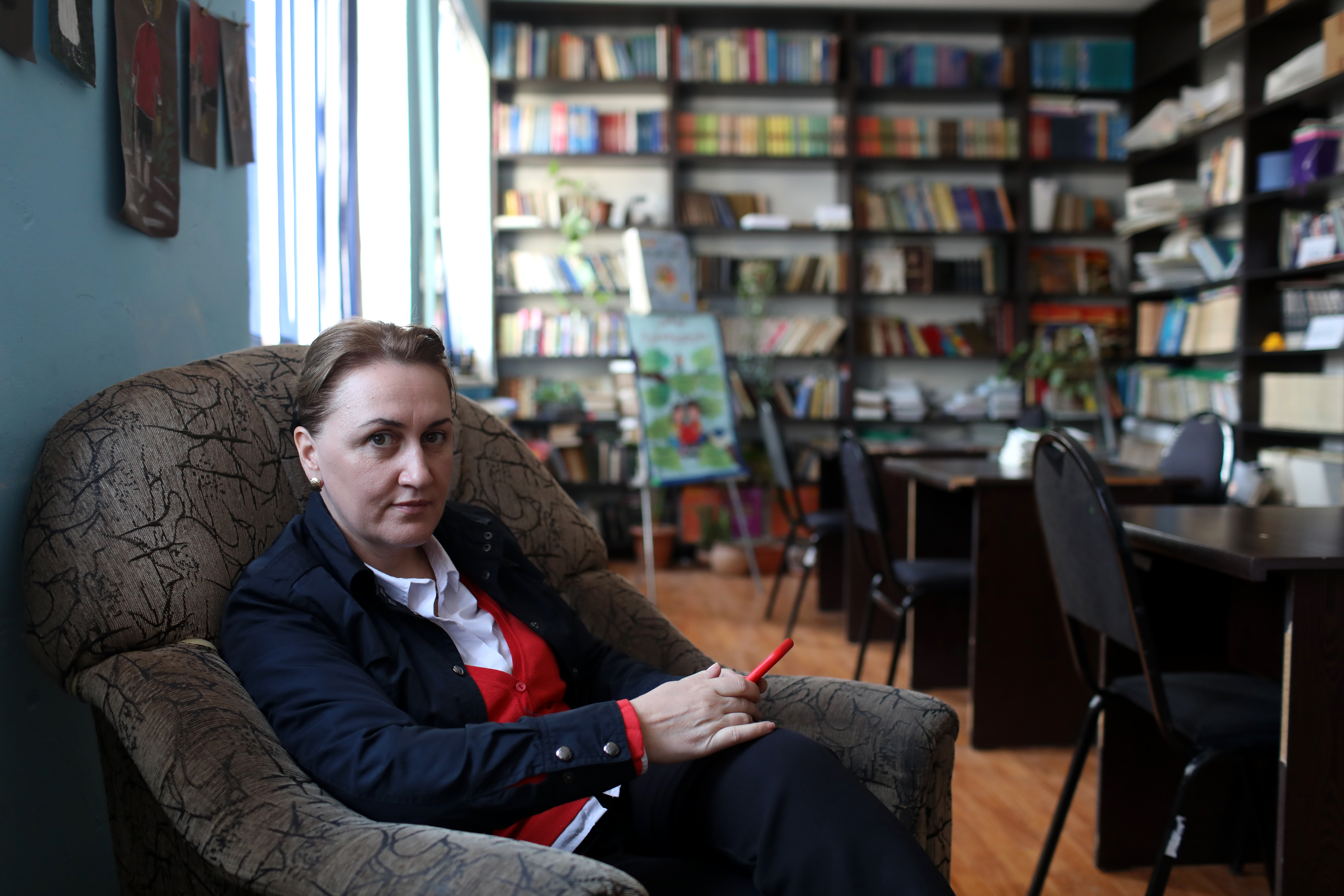 Eka Tabuashvili, Principal of Tbilisi Public school No. #182 is sitting in a school library
