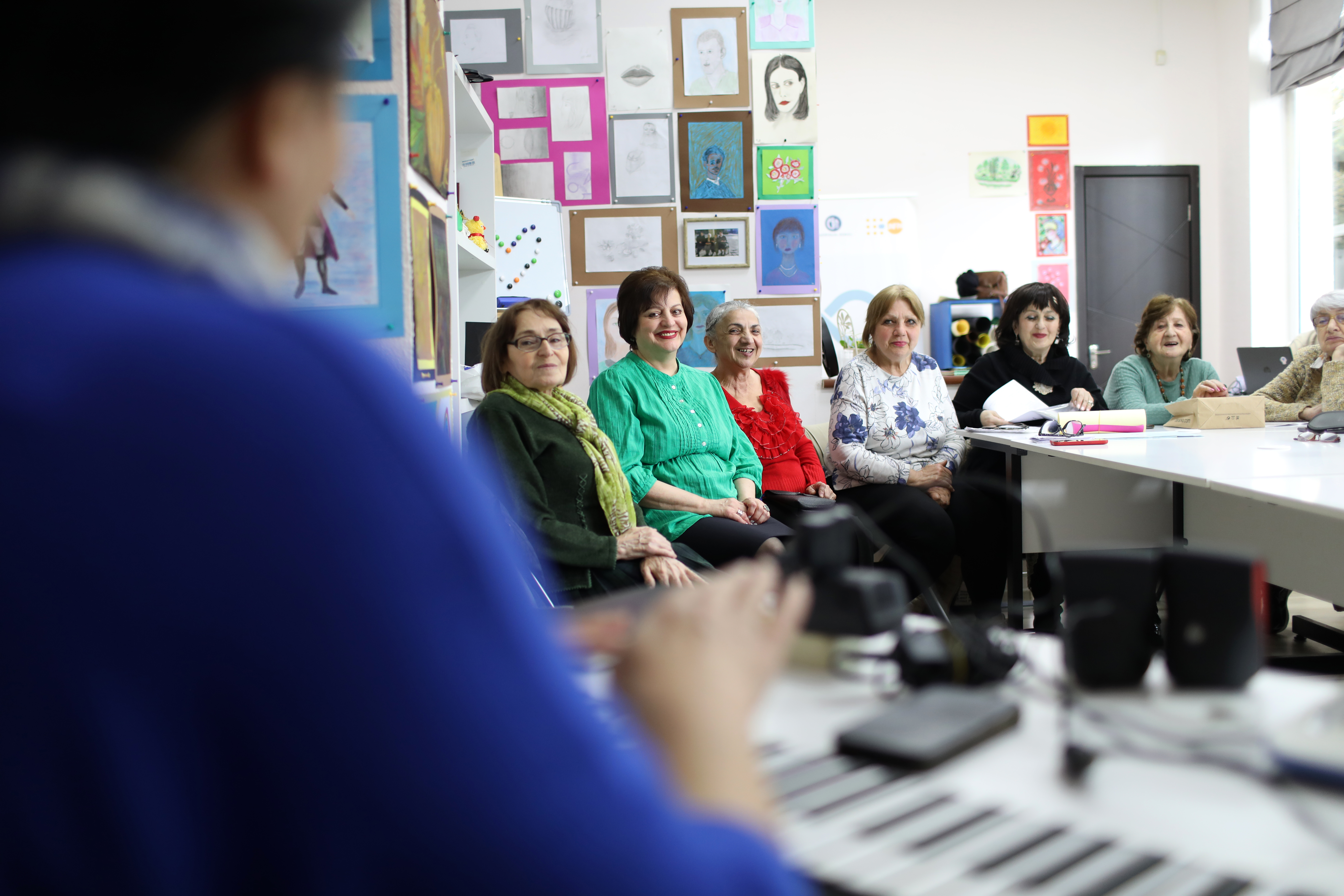 Members of 60+ Club in Tbilisi are having a music lesson