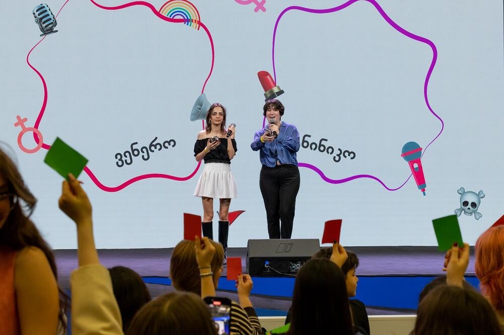 Stand-up comedians standing on a scene