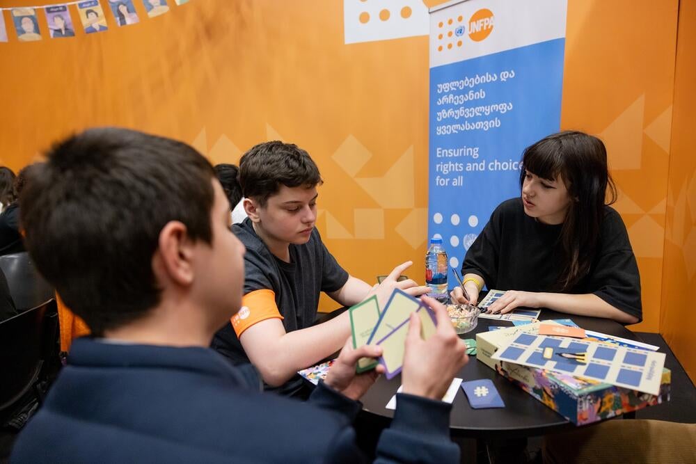 Young people playing a board game