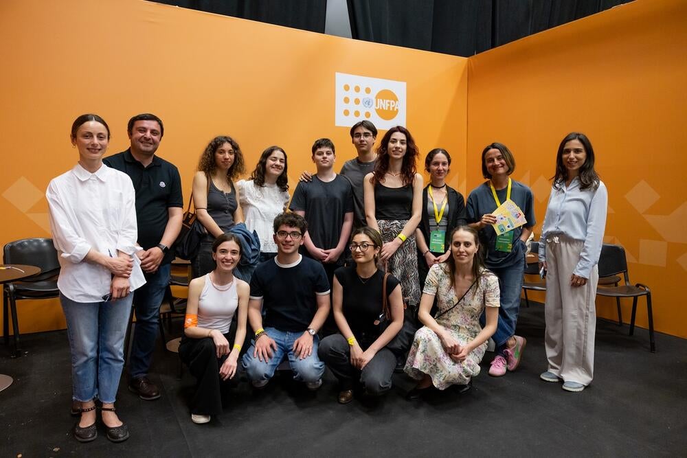 A bunch of people standing together in two row