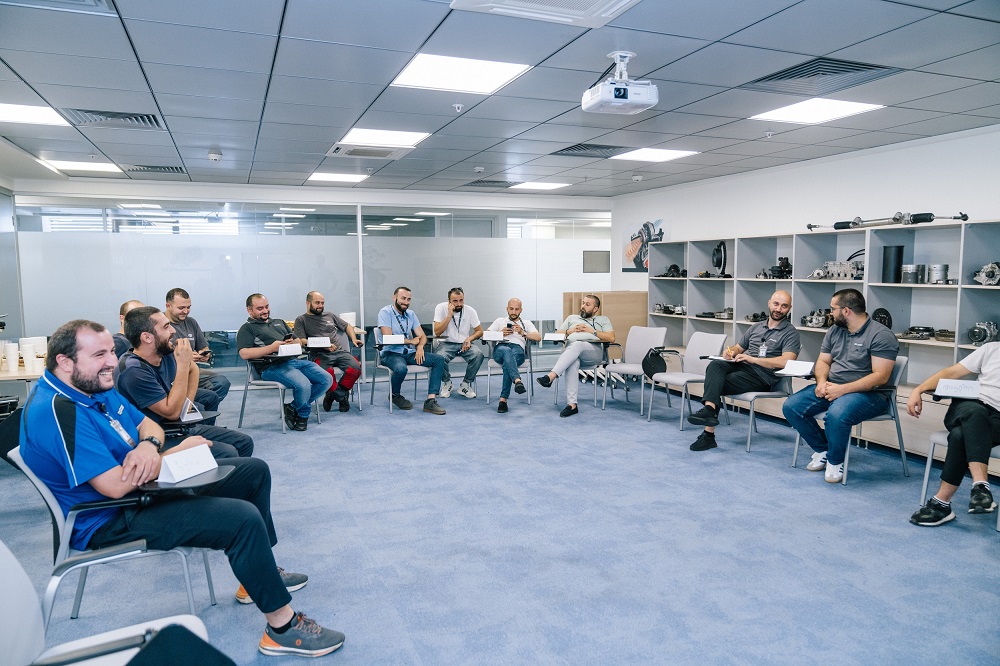 A number of men are sitting together