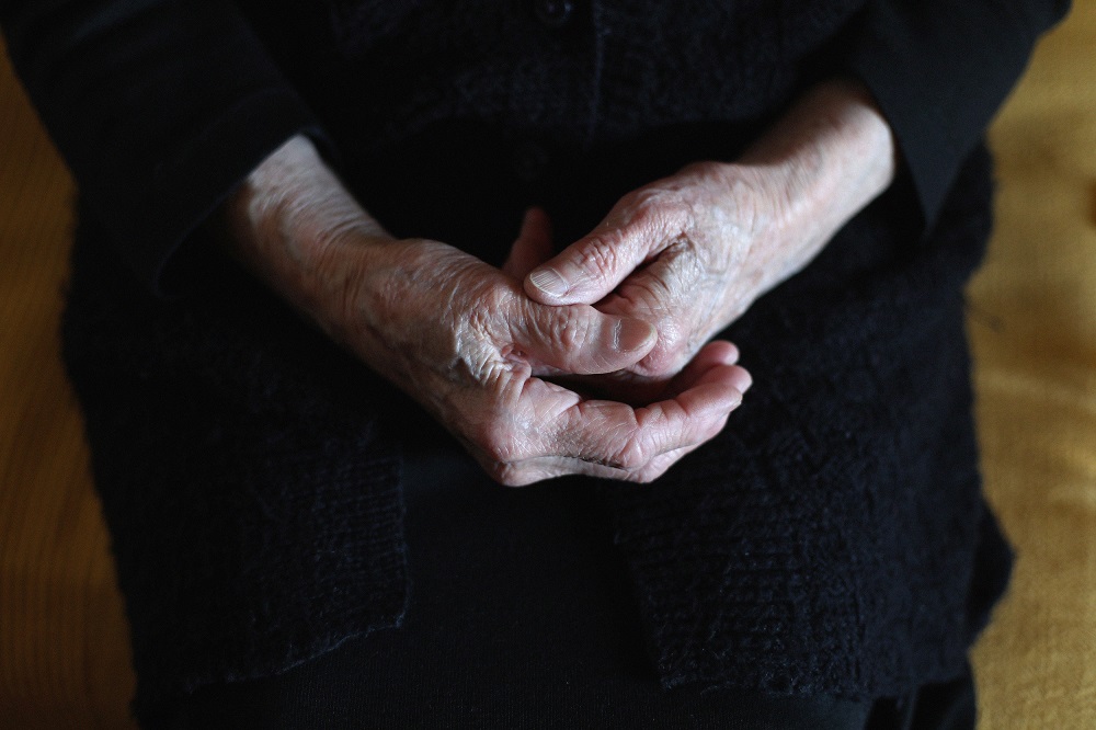 A close up of hands of elder women