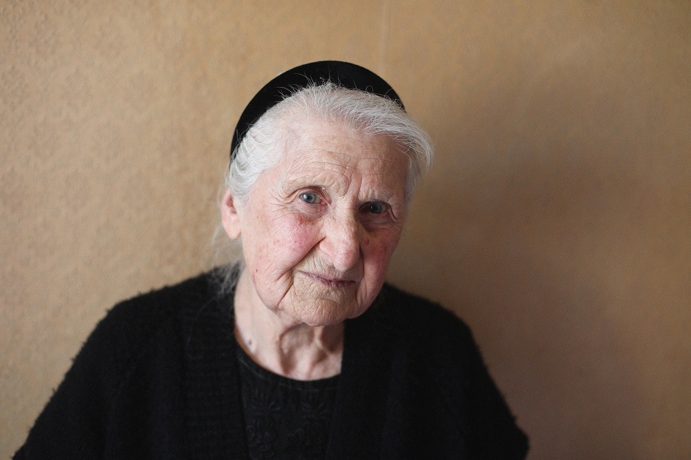 A close up of an elder woman wearing black