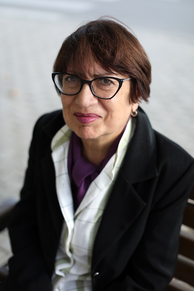 A close up of a woman with short hair and glasses