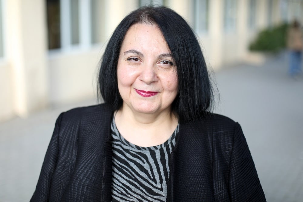 A close up of a woman with short black hair