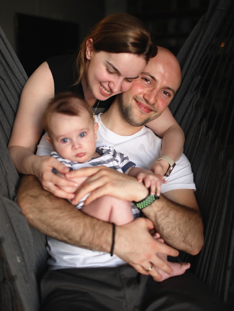 Young parents holding their baby-boy