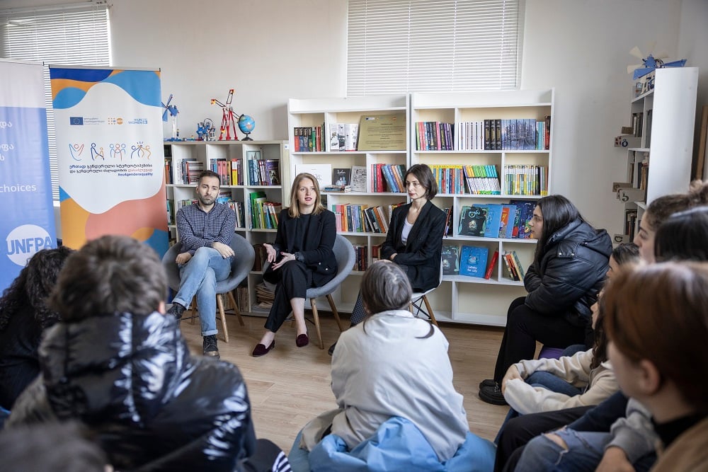 A photo of people sitting on front of young people