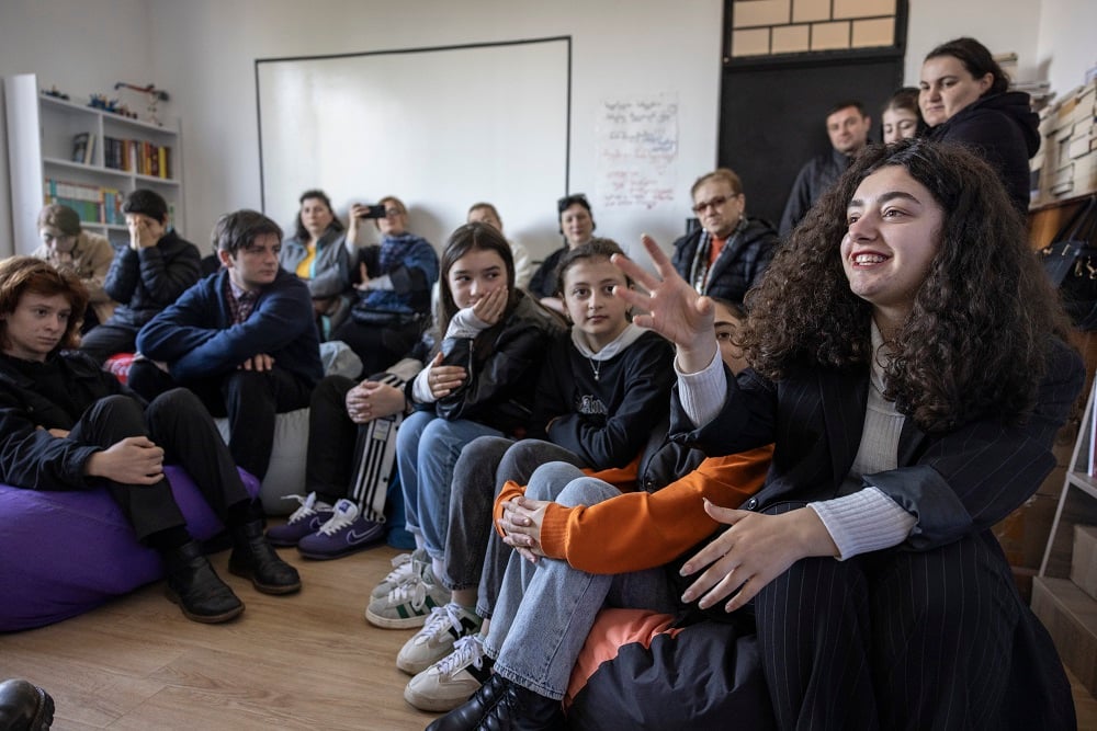 A bunch of young people sitting together