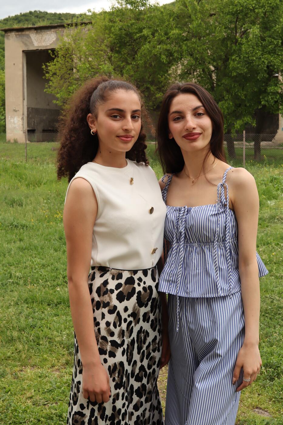 Two sisters from Kvemo Kartli region of Georgia are standing together in a field
