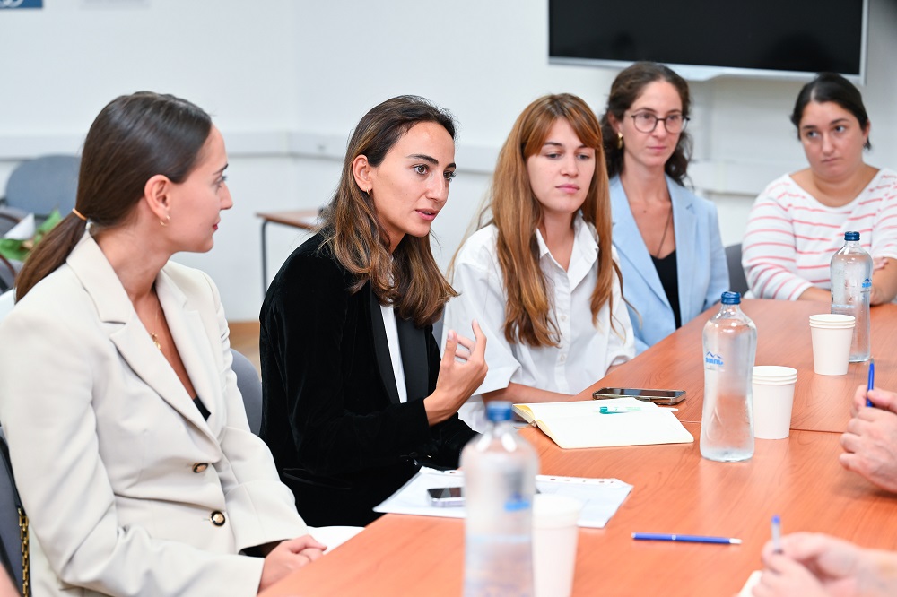 A number of young women sitting together talking