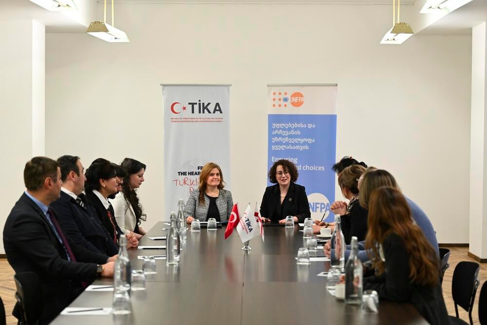 A group of people sitting at a table talking