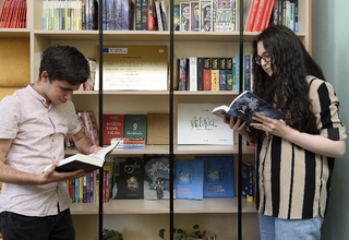 A boy and a girl are reading books