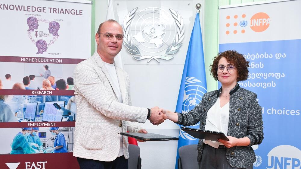 Rector of the East European University, Kakhaber Lazarashvili and Head of UNFPA Georgia CO, Mariam Bandzeladze, shake hands