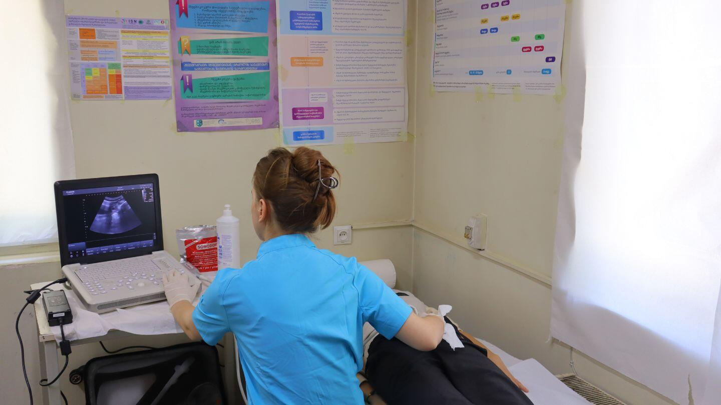 A young female doctor checking up a patient
