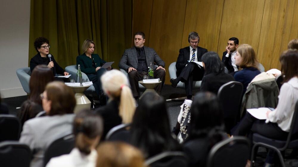 A panel of high-level delegates and the public attending the event