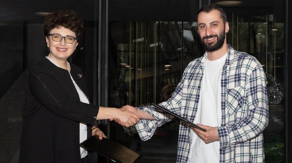 UNFPA Georgia CO Head shakes hands with Meama CEO after signing a MoU