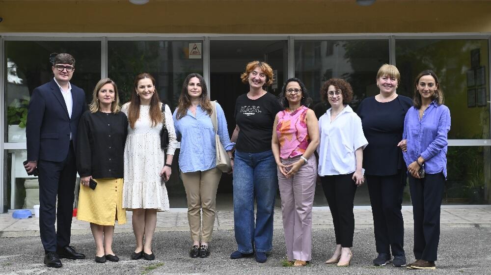 A bunch of people representing UNFPA, AVON and Anti-Violence Network of Georgia are standing outdoors posing for a photo