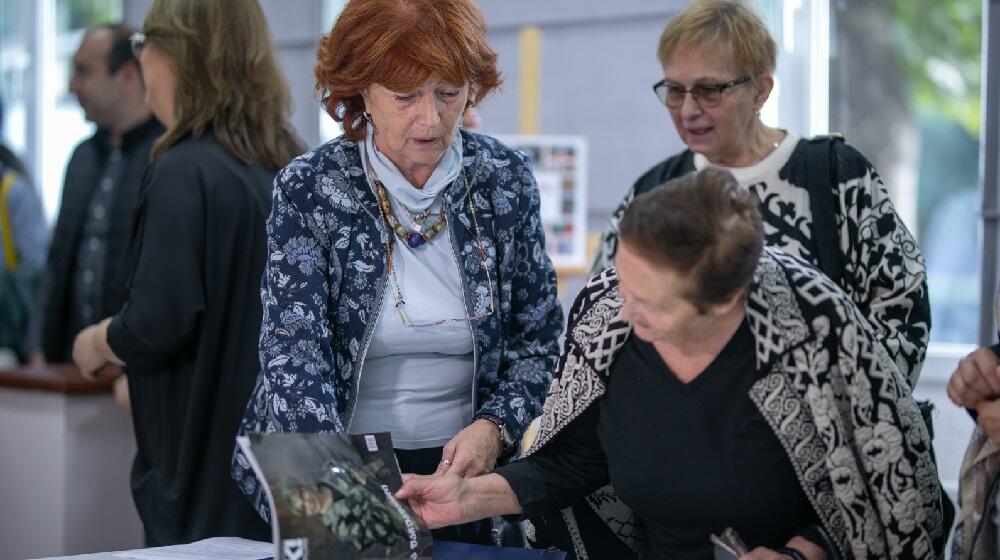 Elder women looking at a magazine cover