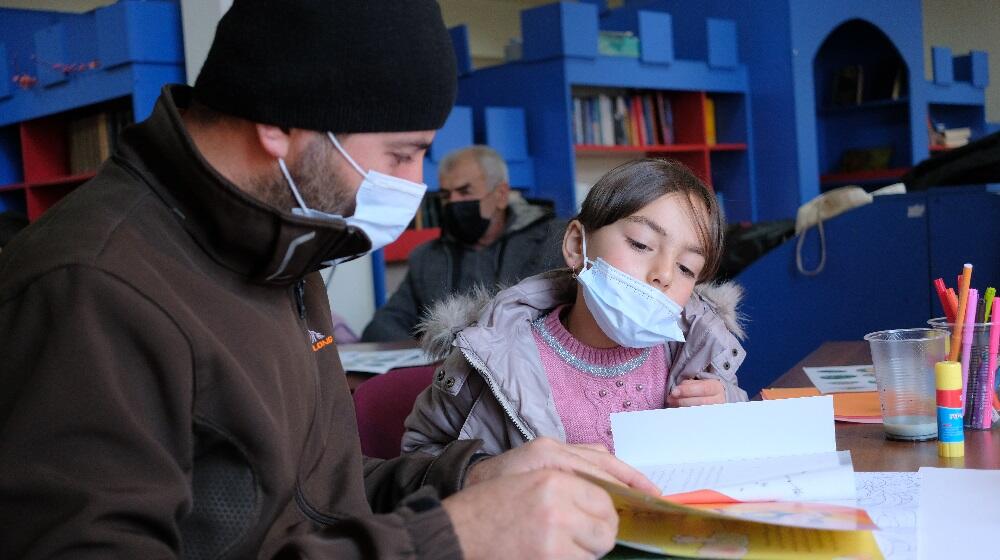 A father and a daughter reading a book