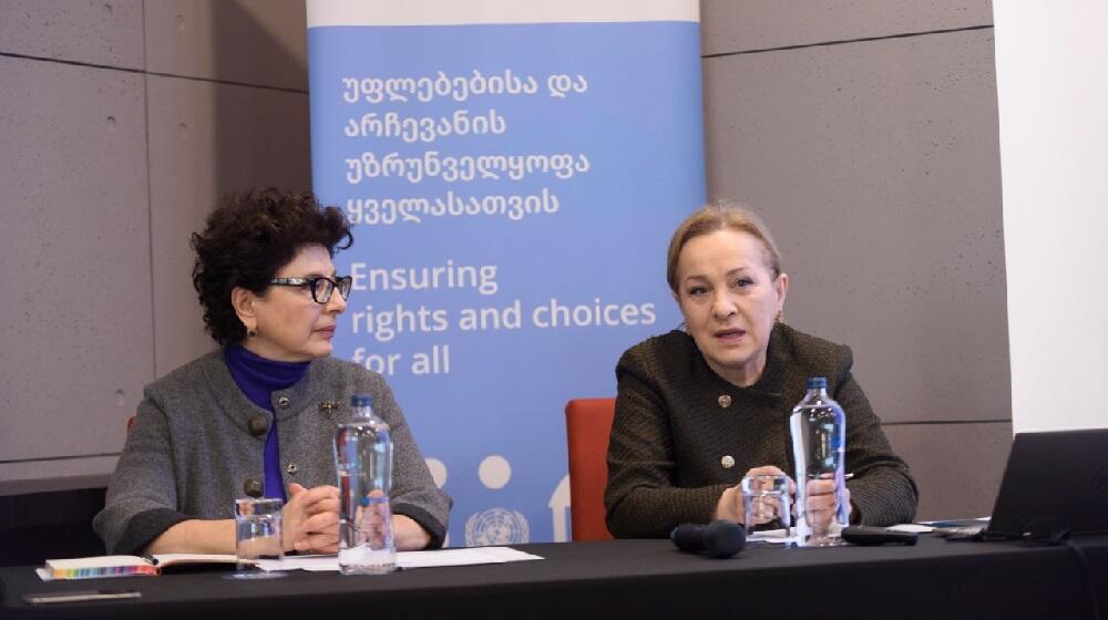 Two women sitting, while one of them is listening to the other talking